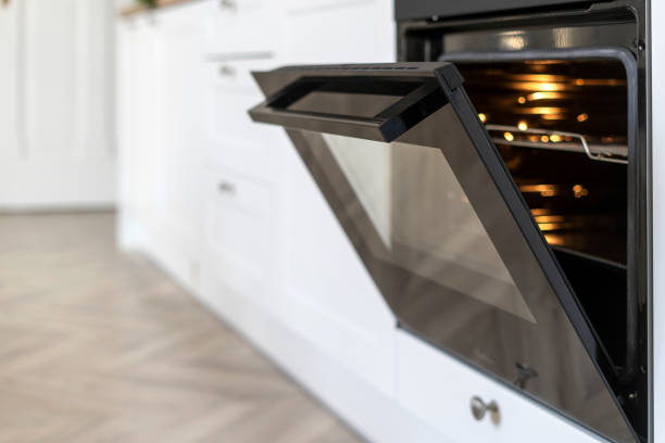 istock Selective focus on opened glass door with handle of modern electric oven 2048141635
