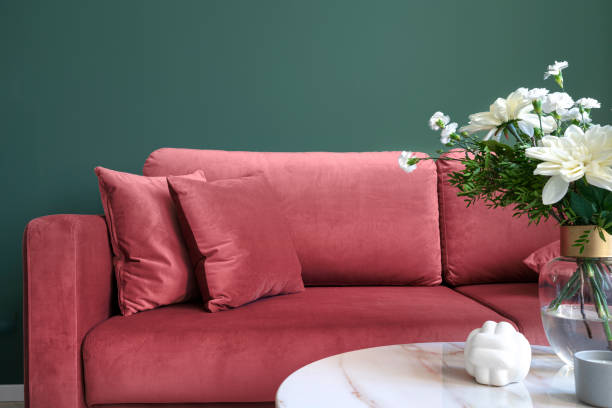 istock Living room interior, sofa with pillows, glass vase with flowers on side table 2048144858
