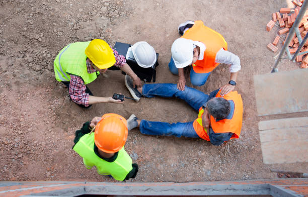 istock senior man construction worker having chest pain sitting on ground at construction site,safety team and engineers help to perform first aid and calling hospital for advanced medical team 2048155917