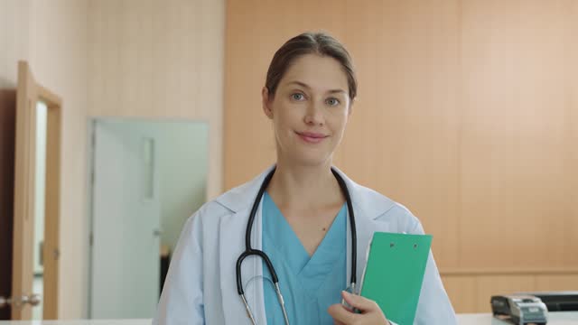 A portrait of a female doctor looking at the camera while standing in the hospital