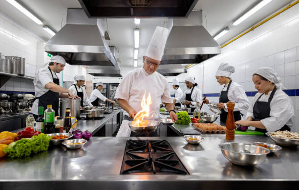 Chef in cooking class with a group of university students