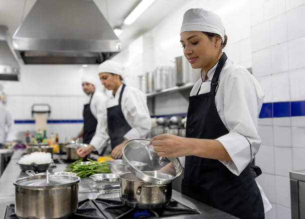 istock Happy woman preparing food in a cooking class 2048176499