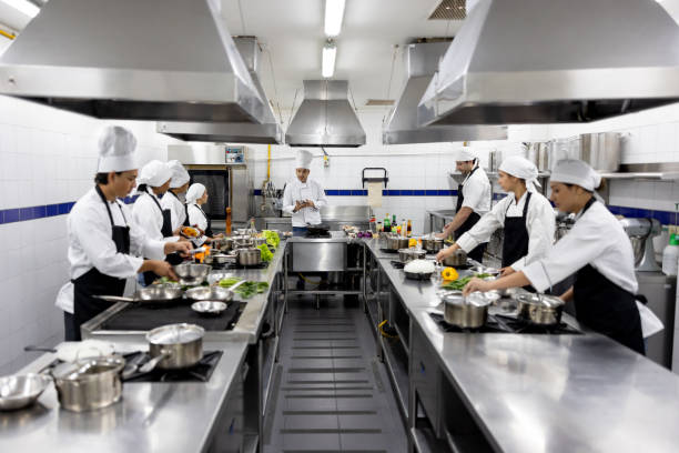 istock Chef teaching a class to a group of students in cooking school 2048176503