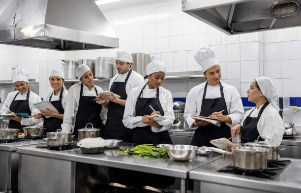 istock Group of students in a cooking class writing a recipe in their notebooks 2048176516