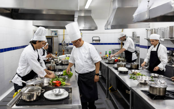 istock Chef supervising a group of students cooking in class 2048176519