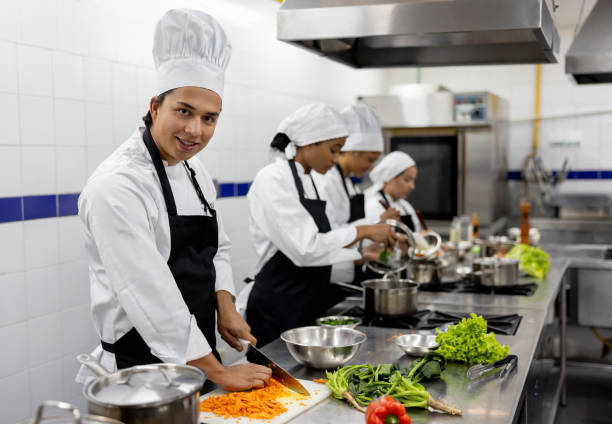 istock Man chopping vegetables in a cooking class 2048177042