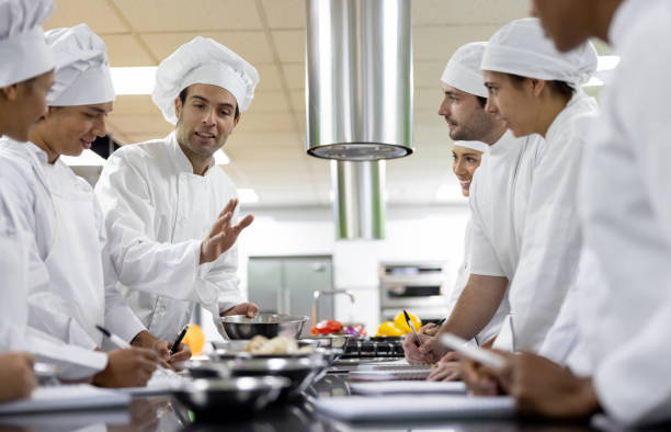 istock Chef teaching a group of students in a cooking class 2048177056