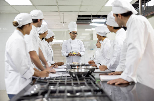 istock Chef teaching a cooking class to a group of students 2048177061