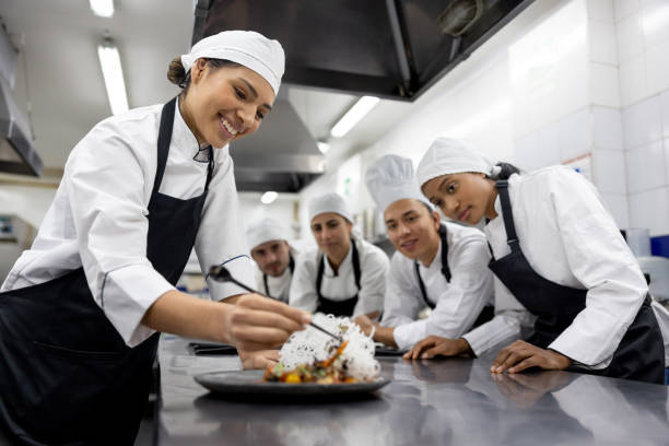 Happy student decorating a plate in a cooking class