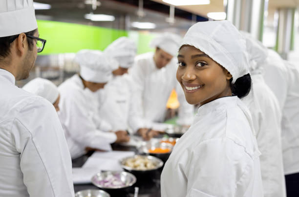 Happy woman smiling at the camera in a cooking class