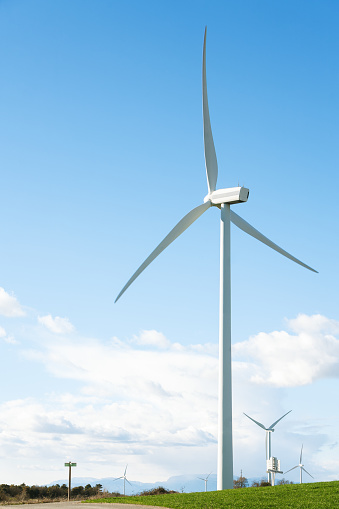 big wind turbine with its big blades and blue sky in the background. renewable energies.