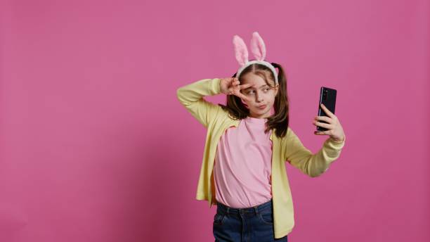 istock Confident happy young girl taking photos on smartphone webcam 2048205342