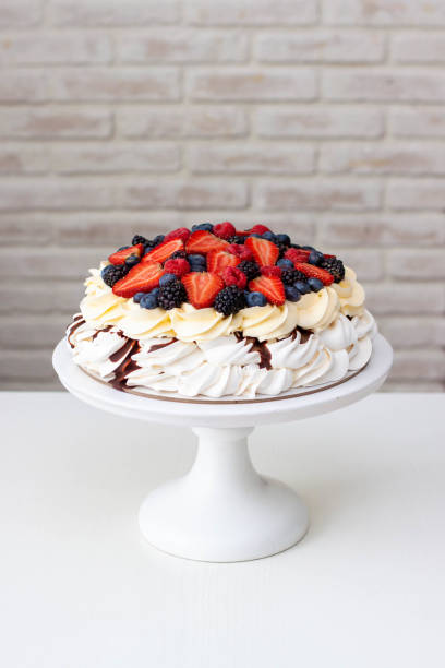 pavlova cake with whipped cream cheese, chocolate sauce and fresh berries on grey background - large cheese beautiful red zdjęcia i obrazy z banku zdjęć