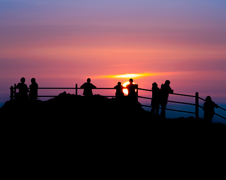A picture of people enjoying the sunset at Hartland Quay, Devon.