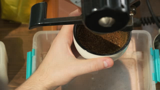 Flavored grounded coffee powder pours from machine into bowl