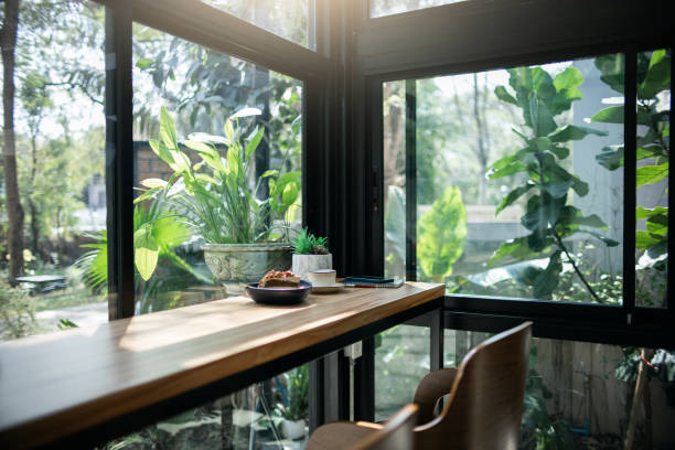 A quiet café corner bathed in soft sunlight by the window, inviting a peaceful moment of rest