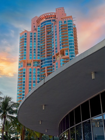 Luxury high rise apartment building in setting sun along Miami Beach.