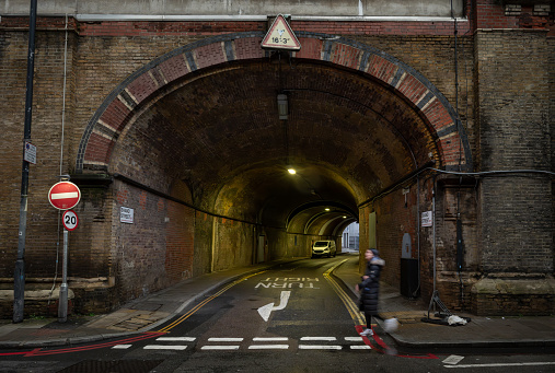 Bermondsey, London, UK: Shand Street passing through a road tunnel under the London Bridge to Greenwich Railway Viaduct. Junction with Crucifix Lane in the London borough of Southwark.