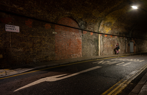 Bermondsey, London, UK: Shand Street passing through a road tunnel under the London Bridge to Greenwich Railway Viaduct in the London borough of Southwark.