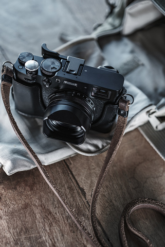 Close up of Black Digital Rangefinder camera in indoor setting.