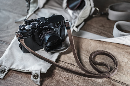 Close up of Black Digital Rangefinder camera in indoor setting.