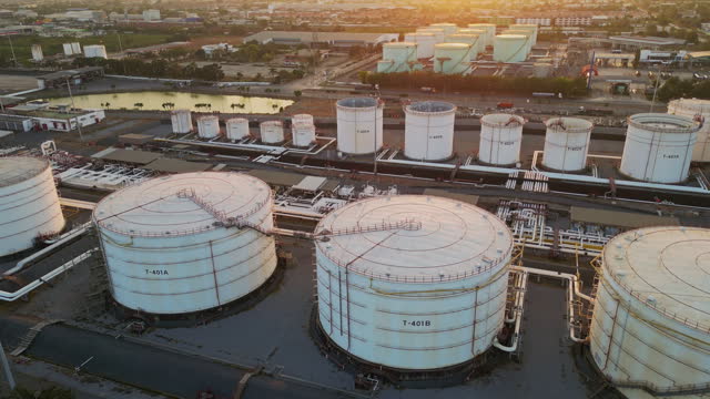 Aerial top view oil storage tank and pipeline at petrol industrial zone, Oil refinery plant industry, Refinery factory oil storage tank and pipeline petrochemical plant.