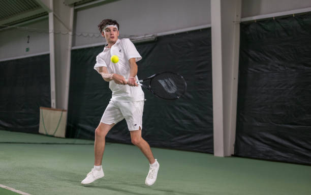 istock Male Tennis Player Hitting Ball With Racket 2048381857