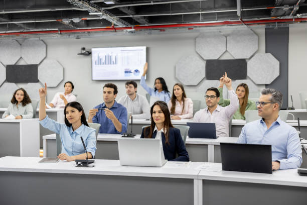 Group of MBA students asking questions in the classroom Group of MBA students asking questions in the classroom and raising their hands - education concepts Master of Business Administration stock pictures, royalty-free photos & images