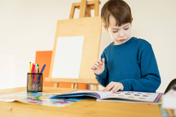 istock 6 year old boy at a drawing lesson 2048389400