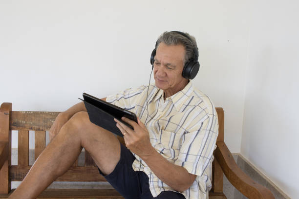 istock Man wearing headphone watching a show on a device 2048402072
