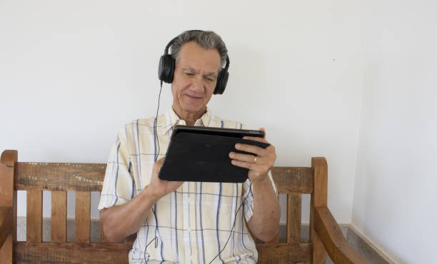 istock Man wearing headphone watching a show on a device 2048412008