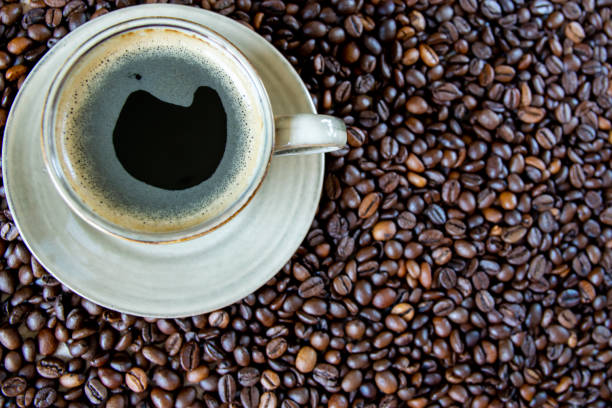 istock Cup with coffe on the roasted coffe beans. 2048423589