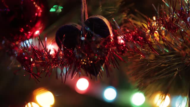 Christmas ornament and lights hanging on Christmas tree