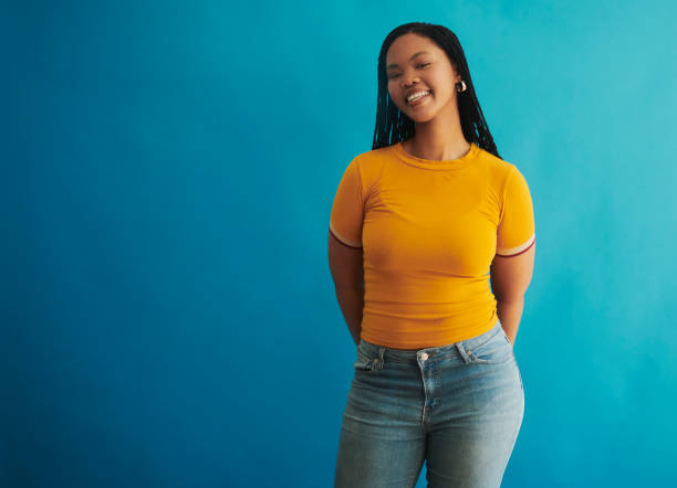 istock A beautiful black woman exuding confidence against a blue background 2048429301