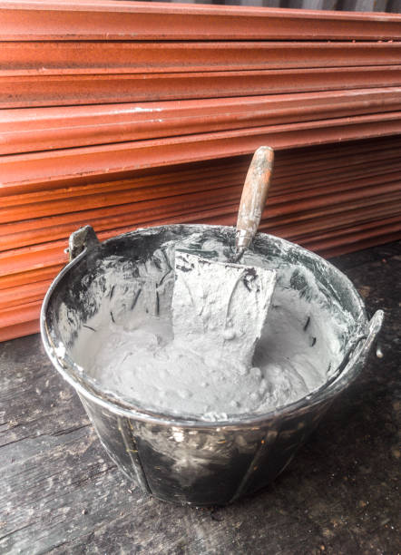 istock Bucket full white adhesive mortar ready for applicate 2048433024