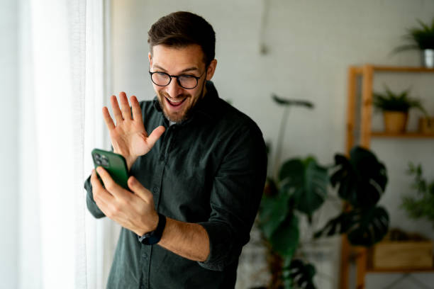 istock Young cheerful man having a video at home 2048463539