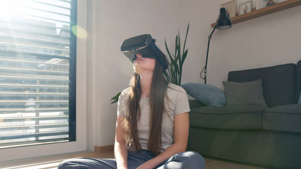 istock Woman immersing in a virtual world using a VR headset 2048474067