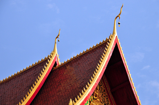 Vientiane, Laos: Wat Mixay, also known as the Temple of Victory - Buddhist temple built during the Lan Xang Kingdom in the 16th century, to celebrate King Sai Setthathirat's victory over the Burmese - Setthathilath Road. Chofa or sky tassel, is a Thai and Lao architectural decorative ornament that adorns the end of wat and palace roofs. It resembles a tall thin bird and looks hornlike