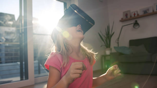 istock Kid with VR goggles looking around and pointing finger 2048478365