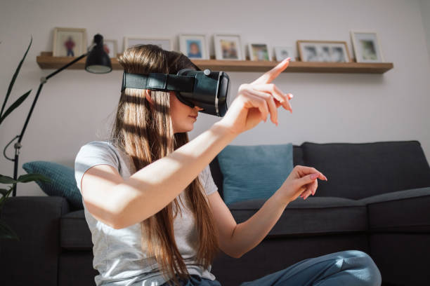 istock Woman wearing virtual reality glasses exploring the augmented world 2048485755