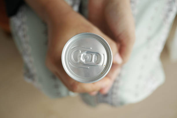 top view of women holding a soft drinks can ..