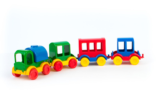 Children's toy, a multi-colored steam locomotive on a white background. For the development of the child