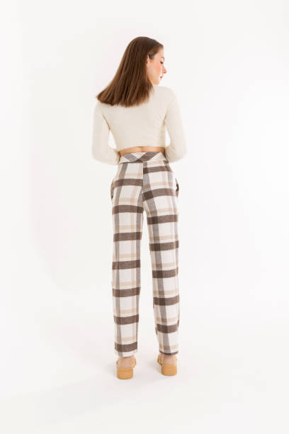 istock Brunette young woman wearing white blouse and multi colored pants. 2048551424