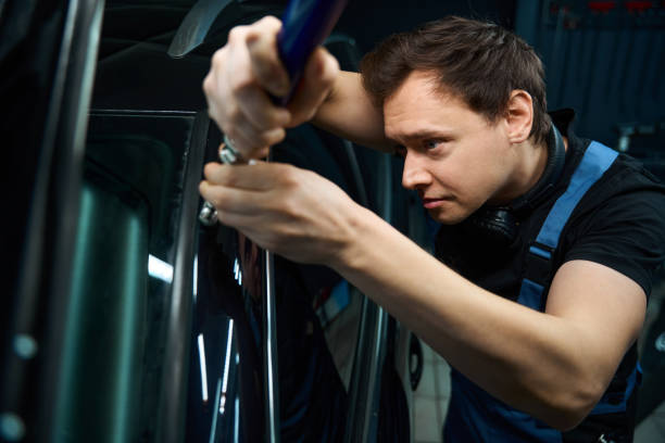 istock Focused collision repair technician is straightening auto bodywork 2048572217
