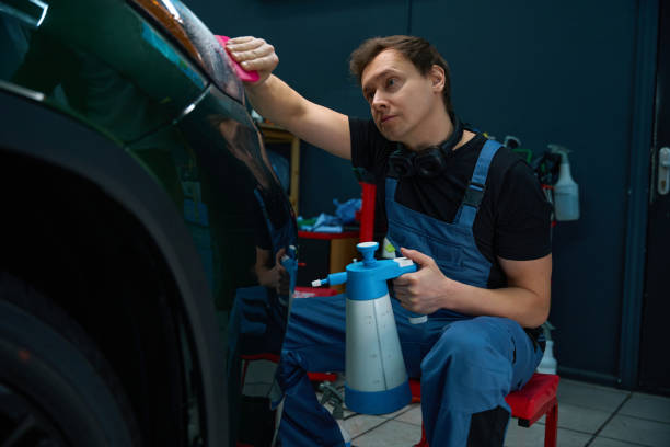 istock Car detailing professional is cleaning automotive headlight 2048572742