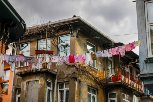 Establishing Shot of Mumbai, India, Showing Clothes Drying in the Windows of a Residential Building