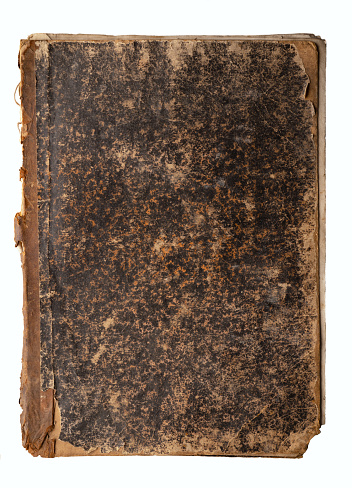 An old book with an aged, worn cover. Isolated on white. Background.