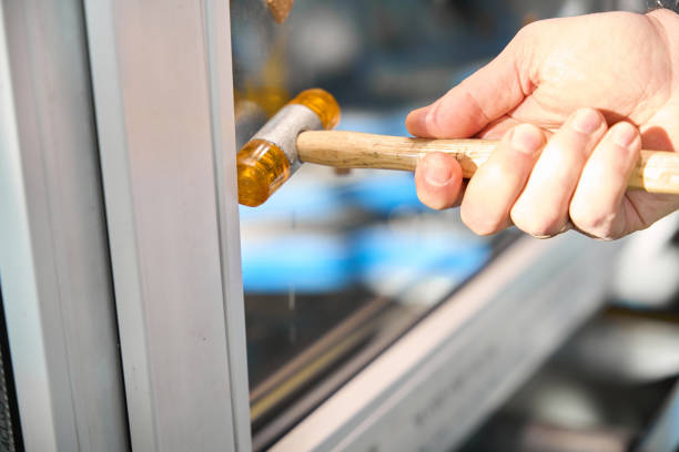 Unrecognizable professional repairman using tools for glazing beads PVC windows construction at factory
