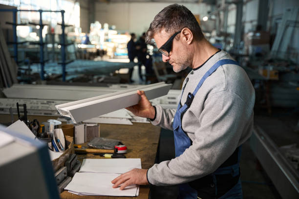 istock Professional production workers in coverall working with different PVC windows 2048610001