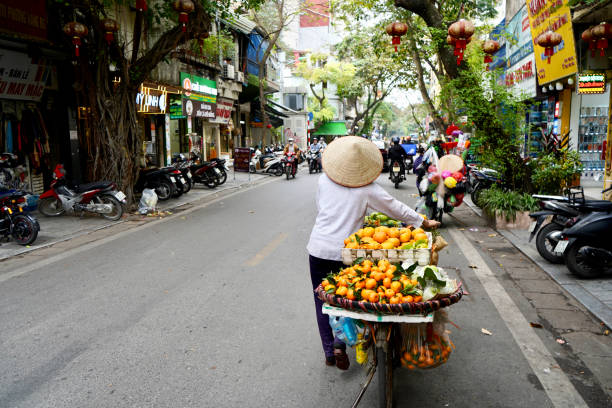 Hanoi, Vietnam - 16 December 2023 : The streets of Hanoi old town are full of motorbikes and traders.